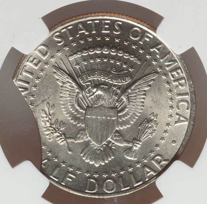 2011 Kennedy half dollar clipped planchet error showing a curved section missing from the coin's edge